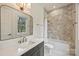 Updated bathroom featuring a tub with shower, designer mirror, and stylish vanity sink at 229 N Canterbury Rd, Charlotte, NC 28211