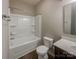 Clean bathroom featuring a shower-tub combo, white fixtures, and dark wood cabinets at 23186 Goose Down Ln, Lancaster, SC 29720