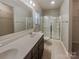 Bathroom boasts double vanity, framed mirror, walk-in shower with glass door, and ceramic tile floor at 23186 Goose Down Ln, Lancaster, SC 29720