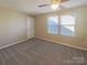 Bedroom with plush carpet, ample light from two windows, and a ceiling fan at 23186 Goose Down Ln, Lancaster, SC 29720