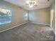 Spacious bedroom with plush carpet, large windows, and neutral decor for a cozy and inviting space at 23186 Goose Down Ln, Lancaster, SC 29720