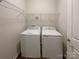 Convenient laundry area with a washer, dryer, and shelving for efficient organization at 23186 Goose Down Ln, Lancaster, SC 29720
