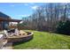 Backyard features a fire pit with seating, lush lawn, and pergola covered outdoor space at 2352 Seagull Dr, Denver, NC 28037