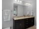 Well-lit bathroom with double sinks, granite countertops, and a large mirror at 2352 Seagull Dr, Denver, NC 28037