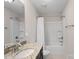 This bathroom features a tub/shower combo, neutral paint and simple sink with custom cabinets at 2352 Seagull Dr, Denver, NC 28037