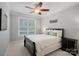 Cozy bedroom with a large window, a ceiling fan, and a comfortable bed at 2352 Seagull Dr, Denver, NC 28037