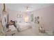 Charming bedroom features a bed, swing chair, desk, and a window allowing for plenty of natural light at 2352 Seagull Dr, Denver, NC 28037
