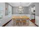 Cozy dining room with a light wood table, white chairs, and a modern chandelier at 2352 Seagull Dr, Denver, NC 28037