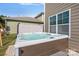 Close-up of backyard hot tub spa with modern features adjacent to the home's exterior at 2352 Seagull Dr, Denver, NC 28037