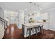 Modern kitchen with a granite-topped island, pendant lighting, and hardwood floors at 2352 Seagull Dr, Denver, NC 28037