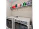 This laundry room features a washer and dryer with storage space at 2352 Seagull Dr, Denver, NC 28037