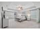 Bright and airy main bedroom with tray ceiling, large windows, and carpeted floors at 2352 Seagull Dr, Denver, NC 28037
