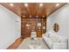 Living room with wood ceiling, built in shelves and ladder, and comfortable seating at 2419 Lemon Tree Ln, Charlotte, NC 28211