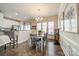 Bright dining area features hardwood floors, a modern light fixture and natural light from three large windows at 2463 Diplomat Ln, Charlotte, NC 28210