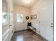 Bright foyer with a front door, bench, and dark hardwood-style flooring at 2463 Diplomat Ln, Charlotte, NC 28210