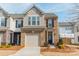 Charming brick townhome with an attached garage and well-maintained landscaping at 2463 Diplomat Ln, Charlotte, NC 28210