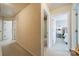 Well-lit hallway leads to bedrooms and bathroom with carpet flooring and neutral paint at 2463 Diplomat Ln, Charlotte, NC 28210