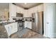 Modern kitchen features stainless steel appliances, granite countertops, and white cabinets at 2463 Diplomat Ln, Charlotte, NC 28210