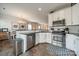 Open concept kitchen featuring stainless steel appliances, granite countertops, and white cabinets at 2463 Diplomat Ln, Charlotte, NC 28210