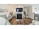 Stylish living room with fireplace, hardwood floors, and comfortable gray seating at 2463 Diplomat Ln, Charlotte, NC 28210