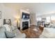 Cozy living room with a fireplace, hardwood floors, and comfortable gray seating at 2463 Diplomat Ln, Charlotte, NC 28210