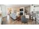 Open-concept living room with hardwood floors seamlessly flows into other living areas at 2463 Diplomat Ln, Charlotte, NC 28210
