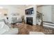 Cozy living room with a fireplace, staircase and modern decor accents at 2463 Diplomat Ln, Charlotte, NC 28210
