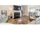 Comfortable living room featuring a fireplace, hardwood floors, and modern decor at 2463 Diplomat Ln, Charlotte, NC 28210
