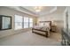 Bright main bedroom features large windows, trey ceiling and neutral décor at 2463 Diplomat Ln, Charlotte, NC 28210