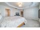 Large main bedroom with neutral decor, trey ceiling, and multiple doorways at 2463 Diplomat Ln, Charlotte, NC 28210