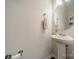 This powder room features a pedestal sink, modern fixtures, and a neutral color scheme at 2463 Diplomat Ln, Charlotte, NC 28210