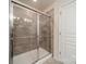Walk-in shower featuring glass door, and decorative tile at 2463 Diplomat Ln, Charlotte, NC 28210