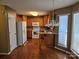 Kitchen has wood floors, a breakfast bar, and white appliances at 3016 Pennridge Pl, Matthews, NC 28105