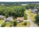 Aerial view of a charming home surrounded by lush greenery and a lake view at 329 Squirrel Ln, Clover, SC 29710