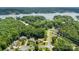 Beautiful aerial view of homes and lakefront property surrounded by lush green trees and a tranquil lake at 329 Squirrel Ln, Clover, SC 29710