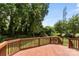 View of a wooden back deck with a railing overlooking a lush, green backyard at 329 Squirrel Ln, Clover, SC 29710