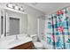 This bathroom includes a single sink vanity, toilet, bathtub, and shower with a patterned curtain at 329 Squirrel Ln, Clover, SC 29710