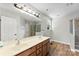 This bathroom features a double sink vanity, large mirror, and shower with tile surround at 329 Squirrel Ln, Clover, SC 29710