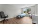 This cozy bedroom features hardwood floors and a large window overlooking the backyard at 329 Squirrel Ln, Clover, SC 29710