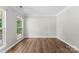 Bright bedroom with wood-look flooring, neutral walls, white trim, and large windows at 329 Squirrel Ln, Clover, SC 29710