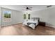 Well-lit bedroom featuring a queen-size bed, ceiling fan, and hardwood floors at 329 Squirrel Ln, Clover, SC 29710