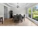 Elegant dining room with wainscoting, chandelier, neutral walls, and tile floors at 329 Squirrel Ln, Clover, SC 29710