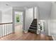 Hallway with hardwood floors, stairs leading to the upper level, and natural light at 329 Squirrel Ln, Clover, SC 29710