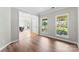 Cozy living room featuring hardwood floors, large windows, and an open doorway to the dining area at 329 Squirrel Ln, Clover, SC 29710