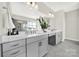 Bathroom with double sink vanity with quartz countertop, grey cabinets, and modern fixtures at 4707 Kingswood Dr, Fort Mill, SC 29707