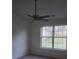 Bright bedroom featuring a ceiling fan, a large double window, and neutral carpet flooring at 4718 Sahalee Ln, Charlotte, NC 28216