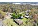 Wide aerial shot of the property set back from the road with a lush lawn, outbuildings, and mature trees at 4937 Lebanon Dr # 1, Charlotte, NC 28273