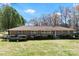 Charming single-story brick home with a well-maintained lawn and blue-shuttered windows on a sunny day at 4937 Lebanon Dr # 1, Charlotte, NC 28273