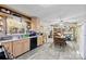 Open kitchen featuring wood cabinets, and a dining area with a stone accent wall and stainless steel appliances at 4937 Lebanon Dr # 1, Charlotte, NC 28273