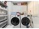 Well-organized laundry room with storage, washer, and dryer at 4937 Lebanon Dr # 1, Charlotte, NC 28273